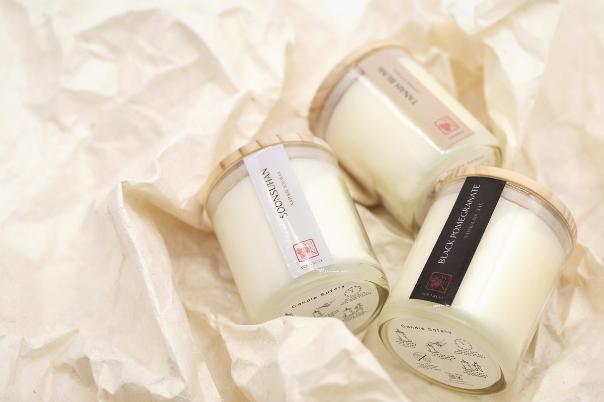 Youn&Co candles resting on soft paper